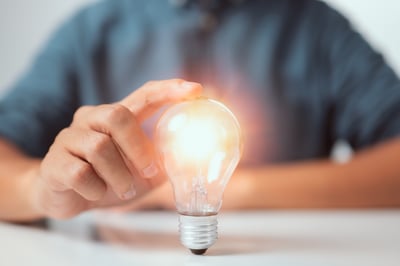 businessman-touching-bright-light-bulb-concept-ideas-presenting-new-innovation