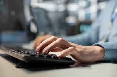 data-center-technician-typing-pc-keyboard-programming-diagnostic-application-scripts-examining
